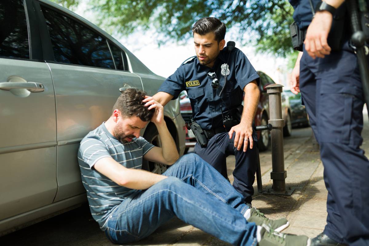 A police officer speaking to someone after a car accident